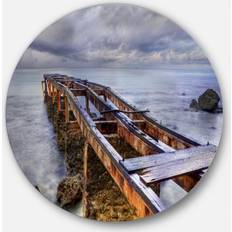 Design Art 'Old Rusty Pier Cloudy Day' Seashore Photo Round Metal Framed Art